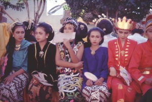 These young women wear tradtional clothing from across Indnoesia.  The oe coverig her face wears a drees from interior Kalimantan, where inhabitants are either animist or Christian.  Teh others are in costumes from Muslim r3egions.  I have been correcting epole for decades whenthe efer to the hijab as traditonal muslim dress.  It is not. 