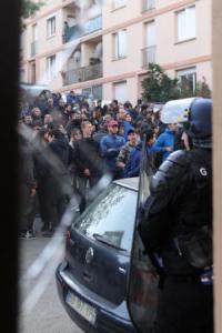 Police hold back Corsican demonstrators in front of Arab populated housing project. Saturday, December 26, 2015.